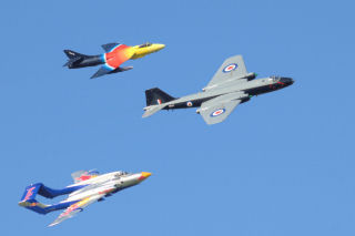 a Canberra, Hunter, and Sea Vixen flying in V formation.
